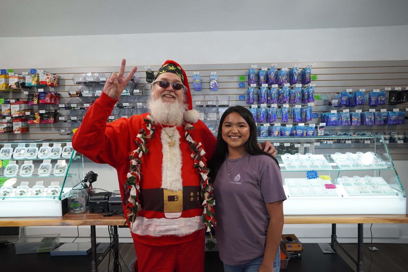 Smoking Santa with a staff member behind the counter