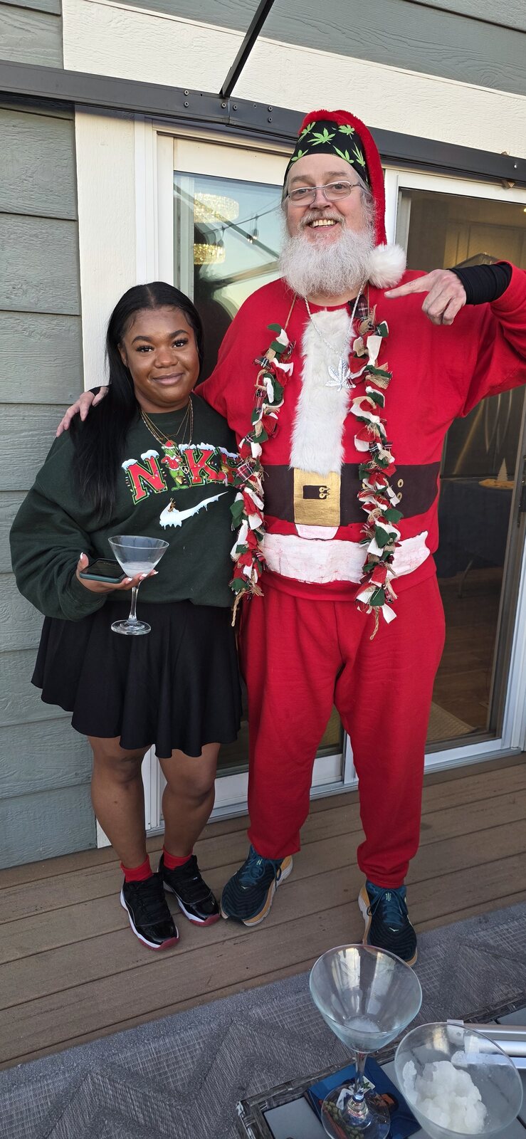 Smoking Santa and a guest raising a glass on a sunny back deck