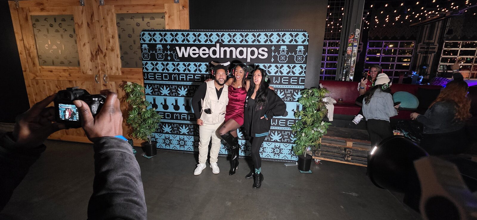 Guests posing for a photographer at a Weedmaps event in Colorado